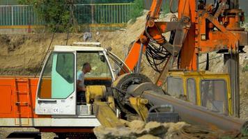 Close up shot of excavating machine digging a hole 4K stock video