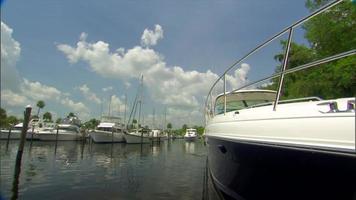 Yacht idles through marina video
