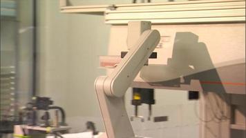 Robotic lab arm moves stacks of vials video
