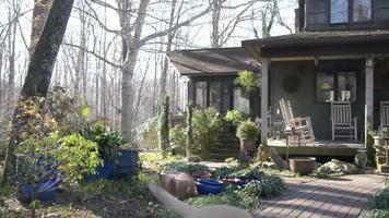 Scene of a farmhouse porch with rocking chairs and the farm dog walking by video