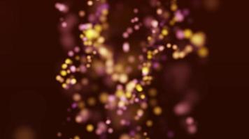 partículas desfocadas amarelas e roxas brilhando no centro da cena video