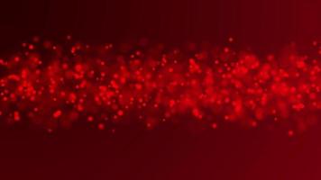 rote 4k weiche Partikel in der Reihe verblassen und bewegen sich auf dunkelrotem Hintergrund video
