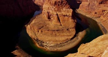 Slow vertical panning shot of the river inside the red canyon in 4K video