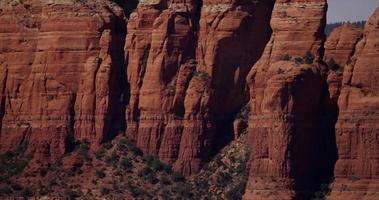 Panning shot of the red walls and peaks of a canyon in 4K video