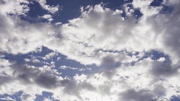 Time lapse of clear and dark altocumulus clouds moving from right to left od the scene in 4K video