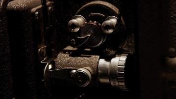 Close up of 8mm movie projector mechanism moving the film in 4K video