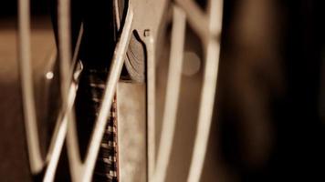 Close up of 8mm movie projector, showing two film reels focusing just one in foreground in 4K video