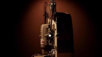 Clip of 8mm movie projector with lens, reels and mechanism moving the film in 4K video