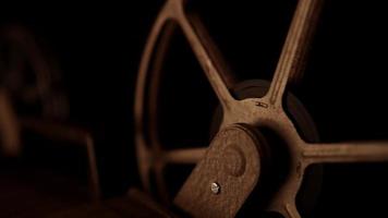 Static shot of film reel spinning on with warm illumination and dark background in 4K video