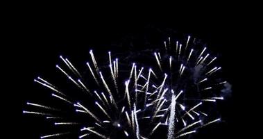 Big group of spectacular fireworks glowing in night sky in 4K slow motion video