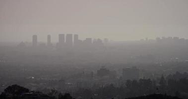 Long shot of skycrapers of Los Angeles with smog in foreground in 4K video