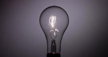 Classic light bulb flickering with vertical filament in 4K