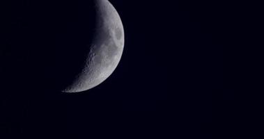  Waxing crescent moon moving from left to right of the scene and disappearing in darkness in 4K