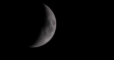 Waxing crescent moon moving so slow from left to the center of the scene in 4K