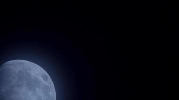 Escena nocturna borrosa de luna menguante azul moviéndose lentamente en trayectoria diagonal en 4k video