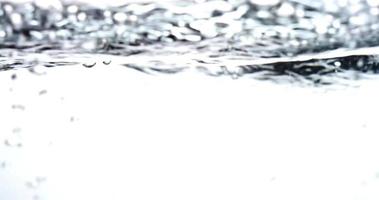 Monochromatic scene of water container with waves and little bubbles in 4K video