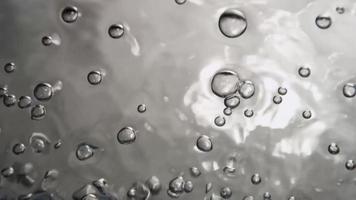 Monochromatic scene of houndred of bubbles moving from lower section of the scene in 4K video