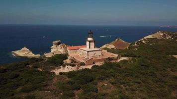 Flying towards a lighthouse and a reef in 4K video