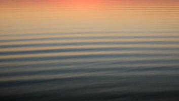 Calm rolling waves reflecting the sunset video