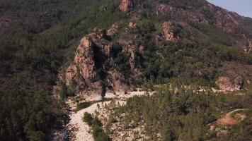 Flying towards rock with creek in 4K video