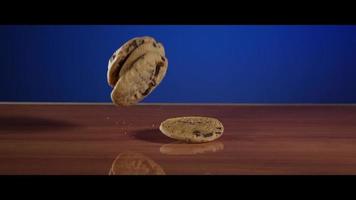 Falling cookies from above onto a reflective surface - COOKIES 025 video