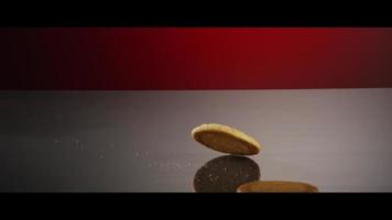 Falling cookies from above onto a reflective surface - COOKIES 214 video