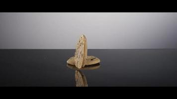 Falling cookies from above onto a reflective surface - COOKIES 022 video