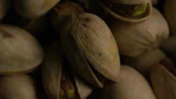 Cinematic, rotating shot of pistachios on a white surface - PISTACHIOS 033 video