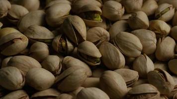 Cinematic, rotating shot of pistachios on a white surface - PISTACHIOS 037 video