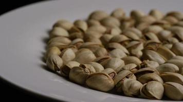 Cinematic, rotating shot of pistachios on a white surface - PISTACHIOS 022 video