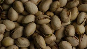 Cinematic, rotating shot of pistachios on a white surface - PISTACHIOS 031 video