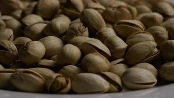 Cinematic, rotating shot of pistachios on a white surface - PISTACHIOS 041