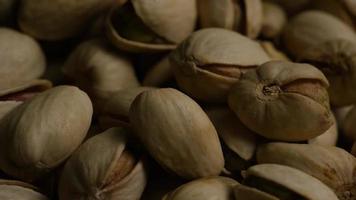 Cinematic, rotating shot of pistachios on a white surface - PISTACHIOS 038 video