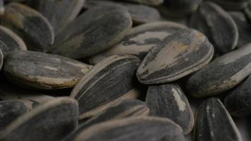 Cinematic, rotating shot of sunflower seeds on a white surface - SUNFLOWER SEEDS 014 video