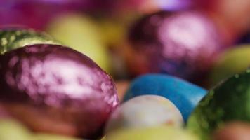 Rotating shot of colorful Easter candies on a bed of easter grass - EASTER 193 video