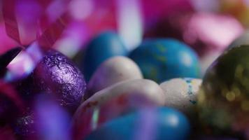 Rotating shot of colorful Easter candies on a bed of easter grass - EASTER 192 video