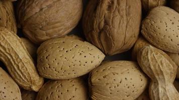 Cinematic, rotating shot of a variety of nuts on a white surface - NUTS MIXED 007 video