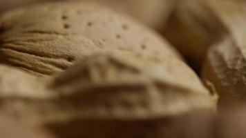 Cinematic, rotating shot of a variety of nuts on a white surface - NUTS MIXED 044 video