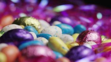Rotating shot of colorful Easter candies on a bed of easter grass - EASTER 186 video
