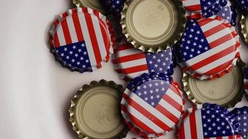 Rotating shot of bottle caps with the American flag printed on them - BOTTLE CAPS 024 video