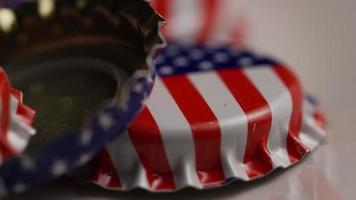 Rotating shot of bottle caps with the American flag printed on them - BOTTLE CAPS 046 video