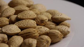 Cinematic, rotating shot of almonds on a white surface - ALMONDS 158 video