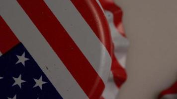 Rotating shot of bottle caps with the American flag printed on them - BOTTLE CAPS 007 video