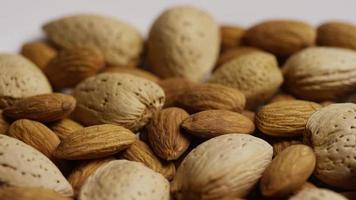 Cinematic, rotating shot of almonds on a white surface - ALMONDS 180 video