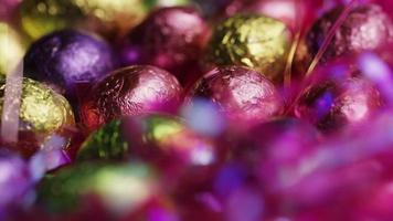 Rotating shot of colorful Easter candies on a bed of easter grass video