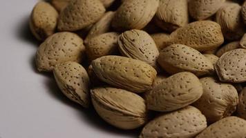 Cinematic, rotating shot of almonds on a white surface - ALMONDS 144 video