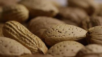 Cinematic, rotating shot of a variety of nuts on a white surface - NUTS MIXED 037 video