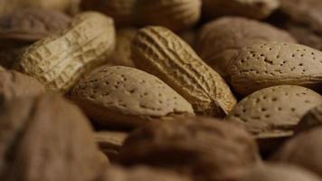 Cinematic, rotating shot of a variety of nuts on a white surface - NUTS MIXED 031 video