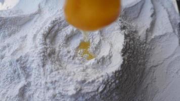 Slow motion of the egg into Bakery Products Process Prepare flour to make cakes. video