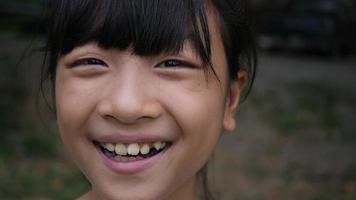Portrait of Asian little girl smiling and looking at camera video